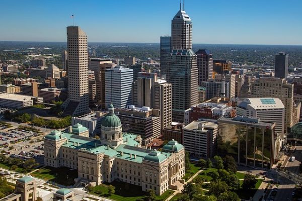 Indiana State Capitol in the foreground of the Indianapolis city skyline during the day